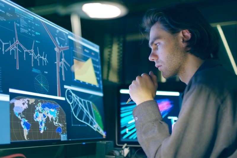 A sustainability consultant analysing information on a computer screen.