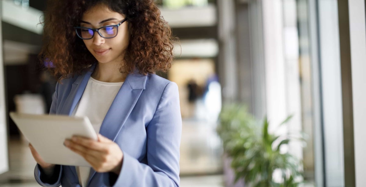 A business analyst reads a tablet.