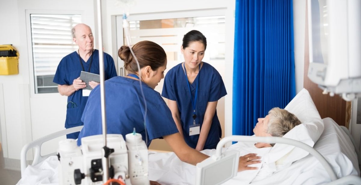 A nurse educator guiding two other nurses.