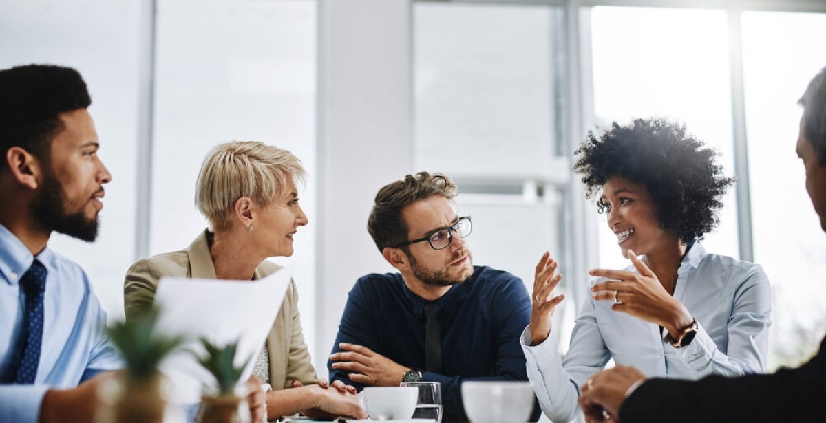 A team of strategic communications professionals engage in discussion.