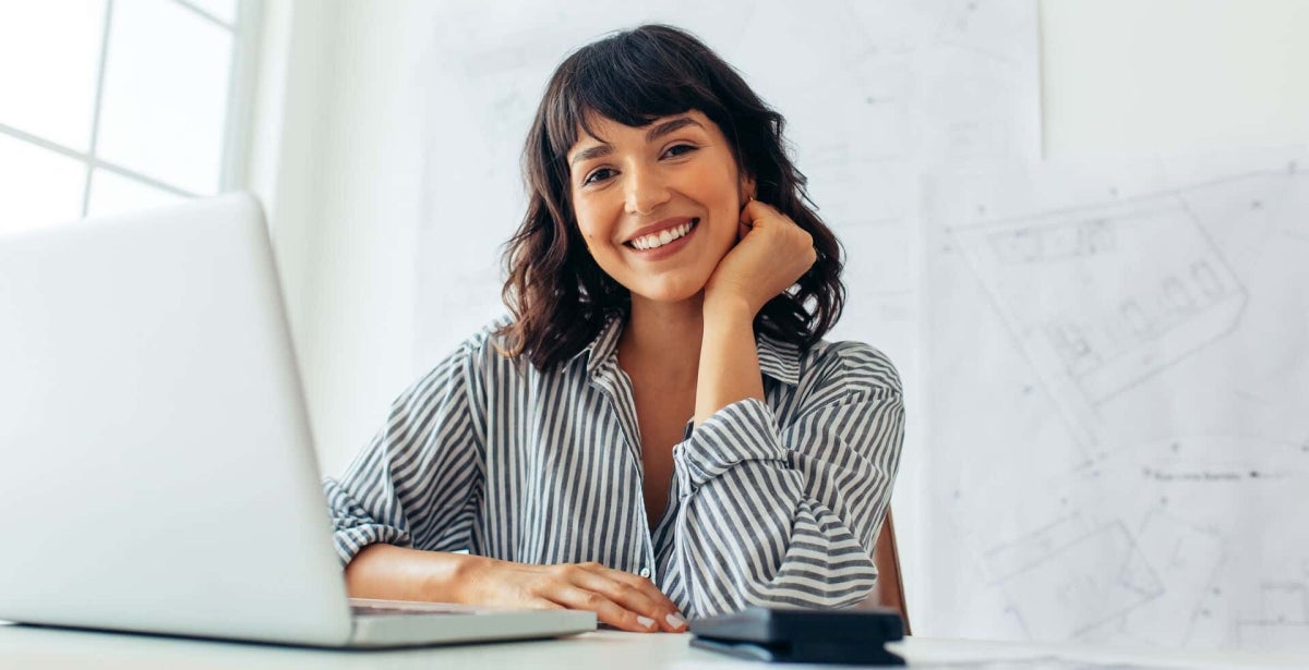 A smiling urban planner in an office.