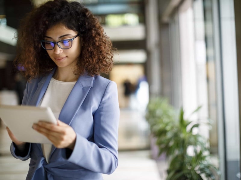 A business analyst reads a tablet.