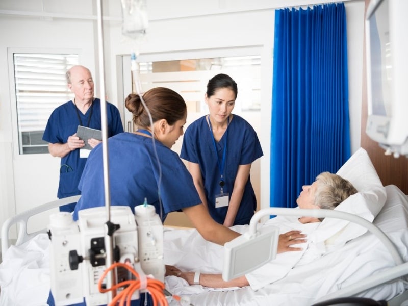 A nurse educator guiding two other nurses.