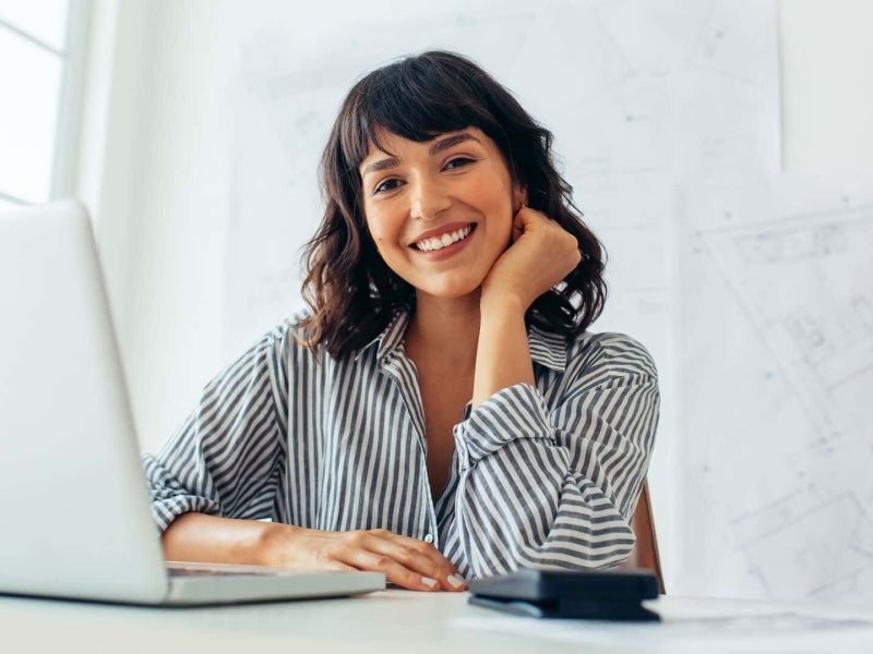 A smiling urban planner in an office.