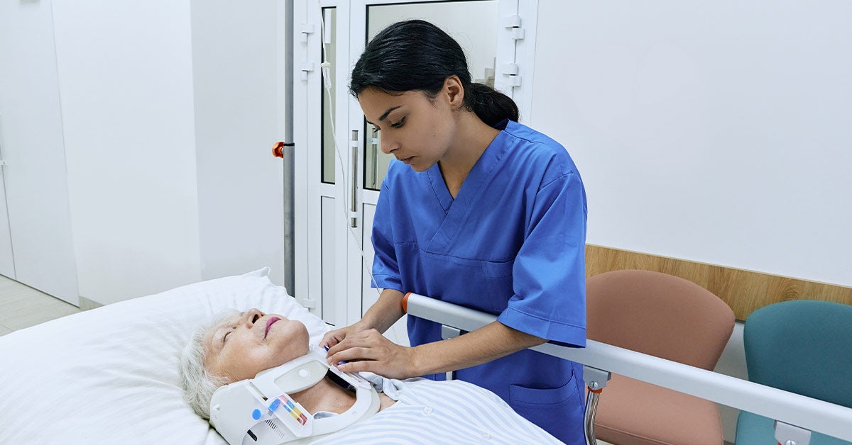 1. A nurse assists an elderly woman in a hospital bed, providing care and support during her recovery.