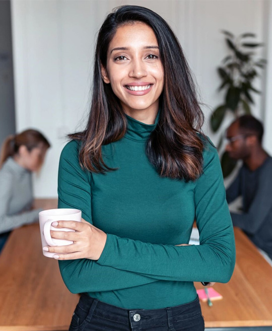 Shot of a young business woman entrepreneur looking at camera in the office.