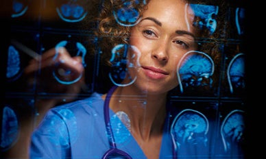 A man smiles while working on a laptop, showcasing a positive and engaged expression.