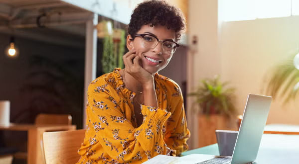 Woman sitting in front of laptop
